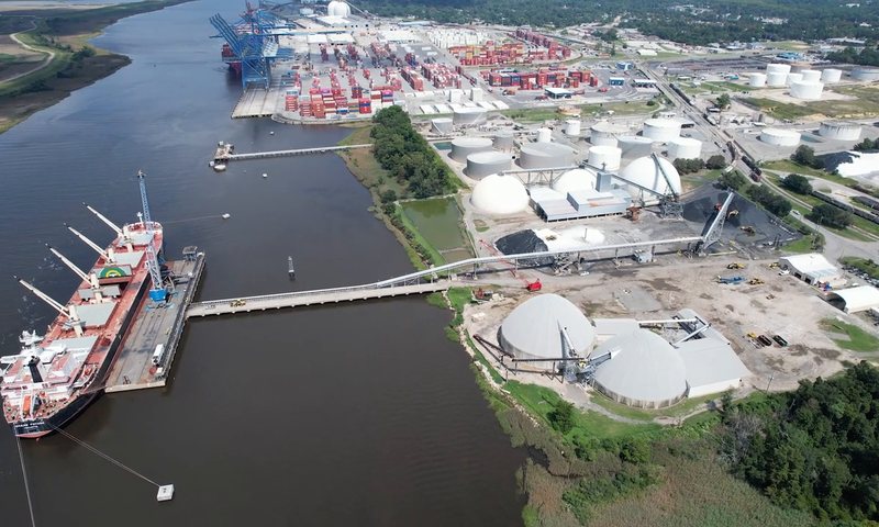 A vessel berthed at a jetty alongside terminal storage